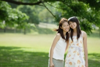 Two young women standing side by side, cheek to cheek - Wang Leng