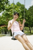 Young woman on swing at playground - Alex Microstock02