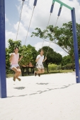 Young women on swings at playground - Alex Microstock02