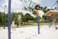 Young women in playground, using swings - Alex Microstock02