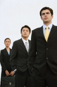 Business people standing in a row, looking away - Alex Mares-Manton