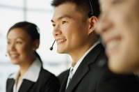 Customer service officers, in a row, focus on man in the middle - Alex Mares-Manton