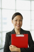 Businesswoman carrying file, smiling at camera - Alex Mares-Manton