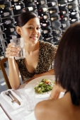 Women dining in restaurant, over the shoulder view - Alex Mares-Manton