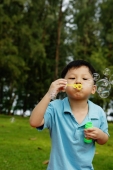 Young boy blowing bubbles - Yukmin
