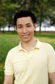 Man in yellow polo shirt smiling at camera - Yukmin