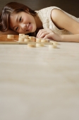 Woman lying on floor, Chinese chess pieces on floor next to her - Alex Mares-Manton