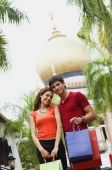 Couple smiling at camera, mosque in the background - Alex Microstock02