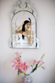 Reflection in the mirror, woman touching her hair - Yukmin