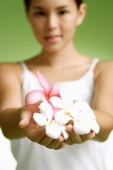 Young woman holding flowers in cupped hands - Alex Microstock02