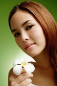 Young woman with long hair holding Frangipani flower - Alex Microstock02