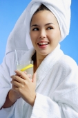 Young woman wearing white bathrobe and towel turban, with drink - Alex Microstock02
