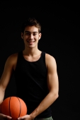 Man standing with basketball, smiling at camera - Alex Microstock02