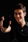 Man holding MP3 player towards camera - Alex Microstock02