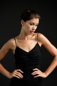 Woman in black tank top, hands on waist, looking down - Alex Microstock02