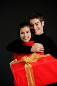 Woman holding red gift, man embracing her - Alex Microstock02