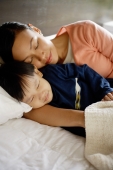Mother and son sleeping on bed - Alex Mares-Manton