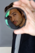 Man looking through lens - Yukmin