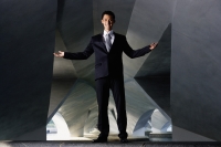 Businessman standing in tunnel, smiling at camera - Yukmin