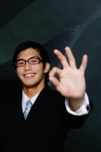 Businessman looking at camera, making hand sign - Yukmin