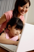 Mother and daughter using laptop - Alex Mares-Manton