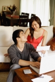 Couple in living room, paying bills - Alex Mares-Manton