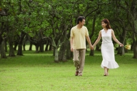 Mature couple in park, holding hands, walking - Alex Mares-Manton