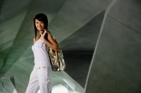 Woman in white tube top, carrying bag over shoulder - Yukmin