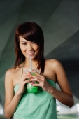 Woman in green top drinking green drink - Yukmin