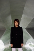 Woman in black jacket standing in tunnel - Yukmin
