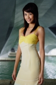 Woman in yellow dress, smiling at camera - Yukmin