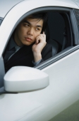Businessman sitting in car, using mobile phone - Alex Mares-Manton