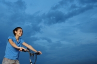 Woman on bicycle, looking away - Yukmin