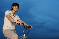 Man on bicycle, smiling at camera - Yukmin