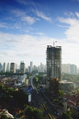 Late afternoon view of the CBD with building construction and office skyscrapers along Jalan Jend Sudirman, Jakarta - Martin Westlake