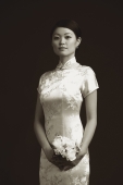 Woman in cheongsam holding bouquet of flowers, portrait - Alex Mares-Manton