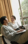 Couple in living room, sitting side by side - blueduck