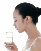 Young woman looking at glass of water - blueduck