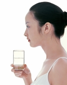 Young woman holding a glass of water, profile - blueduck
