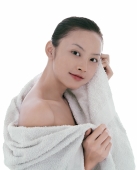 Young woman looking at camera, wrapped in a towel - blueduck