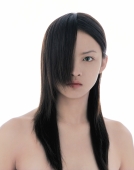 Young woman with long straight hair covering half of her face - blueduck