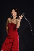 Woman in red dress, spilling wine from glass - Yukmin