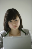 Young woman looking at laptop - Yukmin