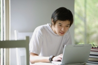 Young man using laptop - Yukmin