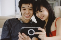 Teenage couple smiling at camera phone - Yukmin