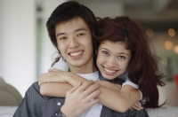 Teenage couple embracing, smiling at camera - Yukmin
