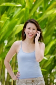 Woman outdoors, using mobile phone - Yukmin