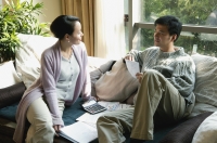 Couple in living room, looking at documents - blueduck