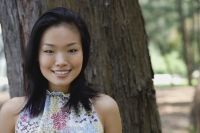 Young woman outdoors, smiling at camera - Yukmin
