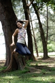 Young woman in park, jumping - Yukmin